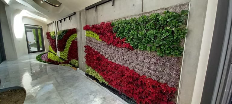 Indoor vertical garden wall with red, white, and green preserved moss and flowers creating diagonal stripe pattern